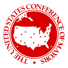 Logo for the US Conference of Mayors with the organization name running along the outside of a red circle containing a white map of the United States with small red stars placed within as if marking cities. 