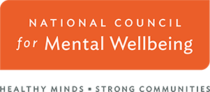 Logo for the National Council for Mental Wellbeing with the organzation name in white on a red banner with a tagline below reading Healthy Minds - Strong Communities. 