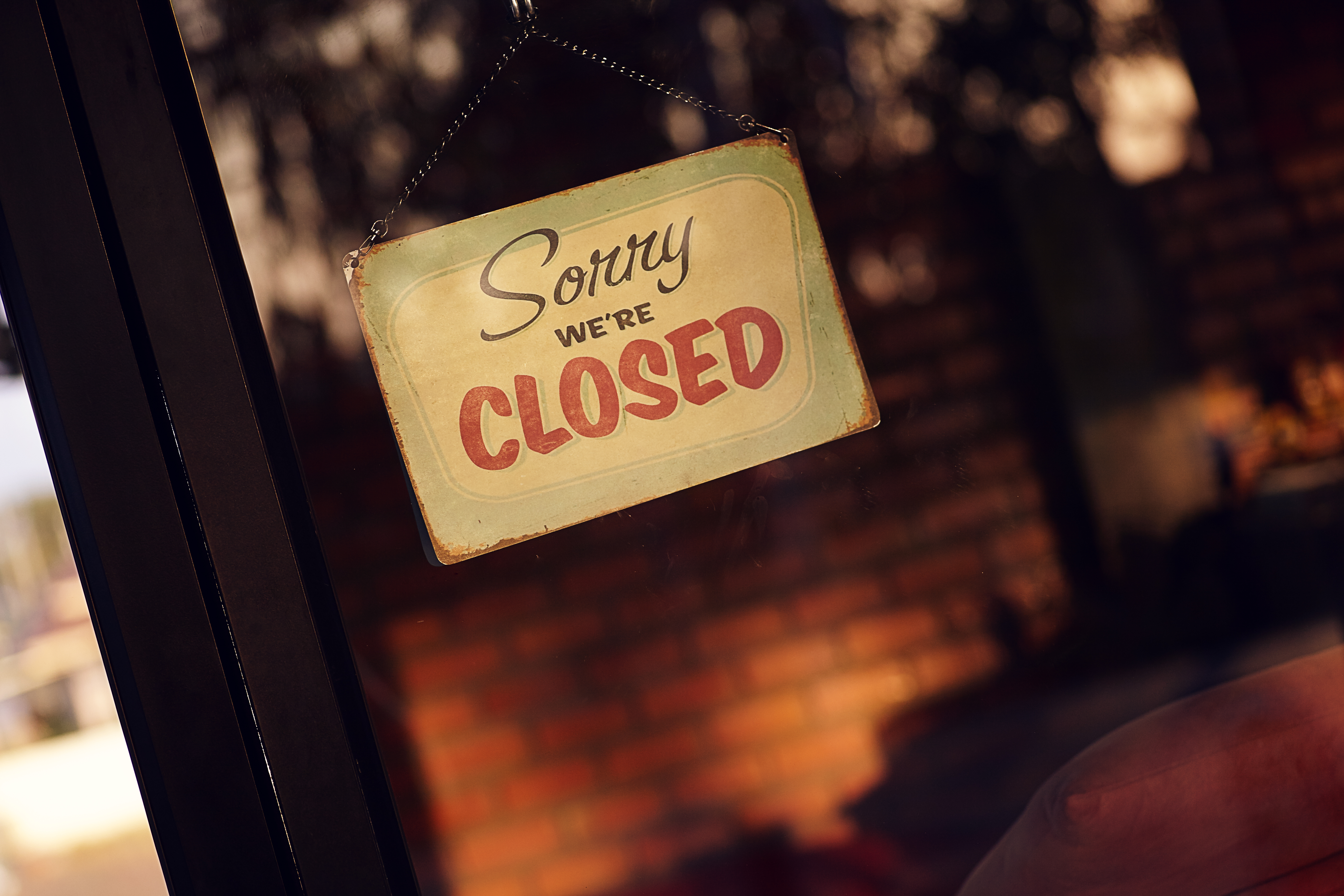 Sign in a storefront that reads, ''Sorry we’re closed''
