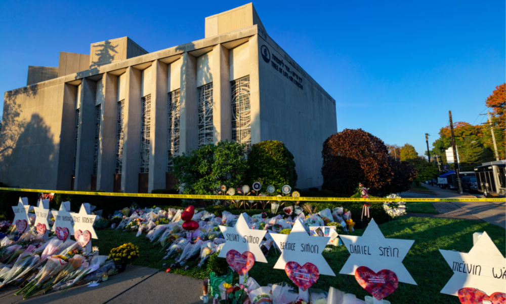 Memorial flowers including the Star of David with victims' names are arranged on the sidewalk and lawn of the Tree of Life Synagogue in Pittsburgh, Pennsylvania. 